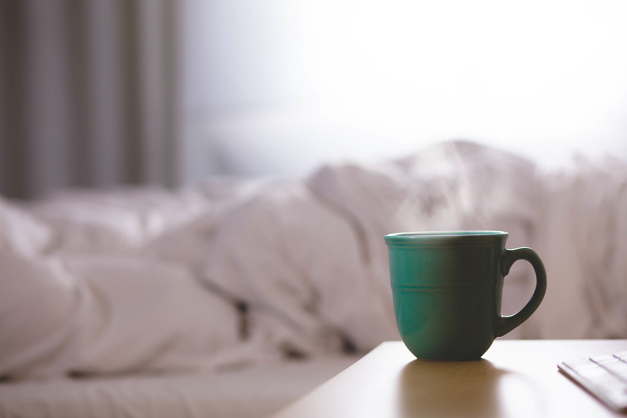 Cup of coffee by bed in the morning