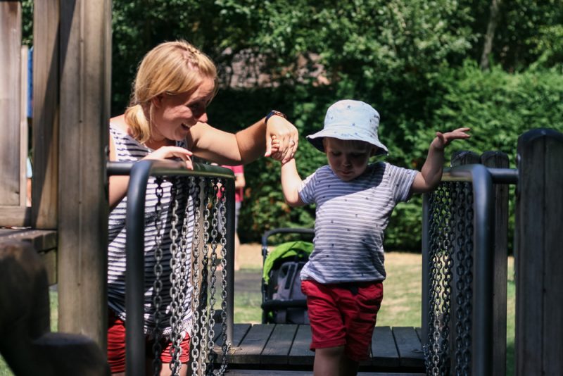 Mommy helping Pickle across the balancing beams