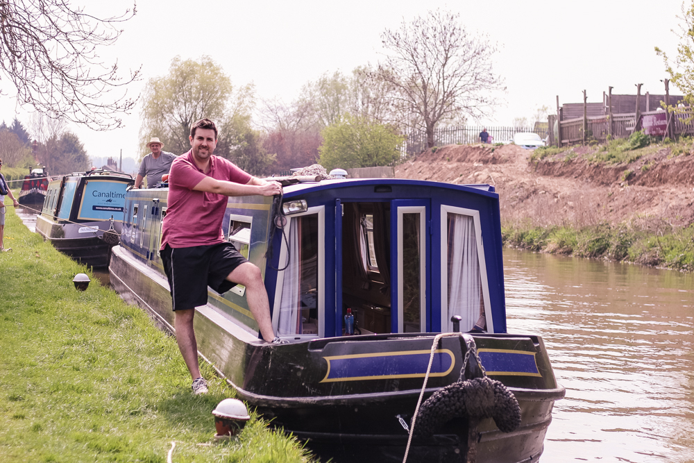 Jim standing at the front of the canal boat, mooring up
