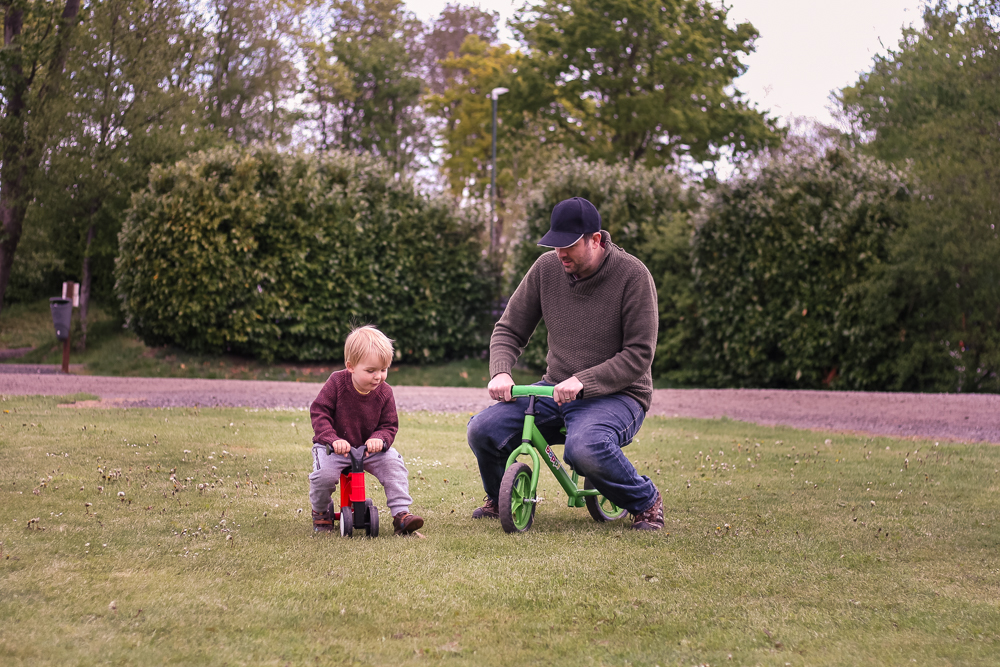 Jim and Pickle playing on their bikes outside the tent.