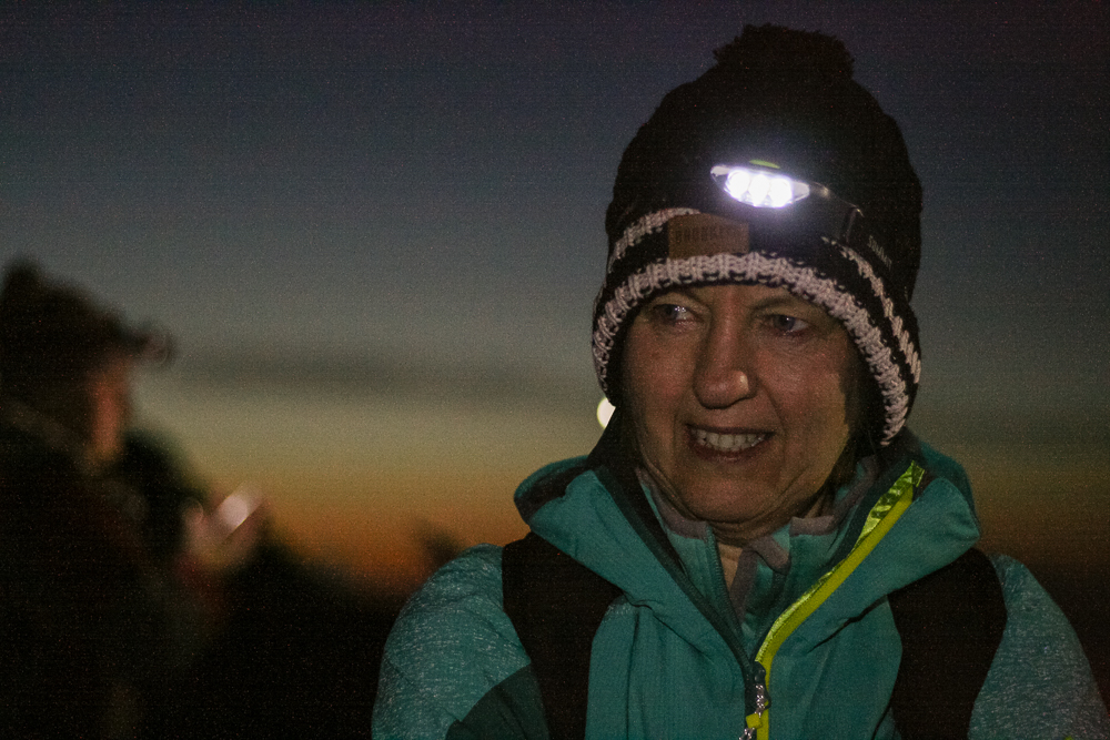 Mom wearing a headtorch at the summit of Snowdon to watch the sunrise