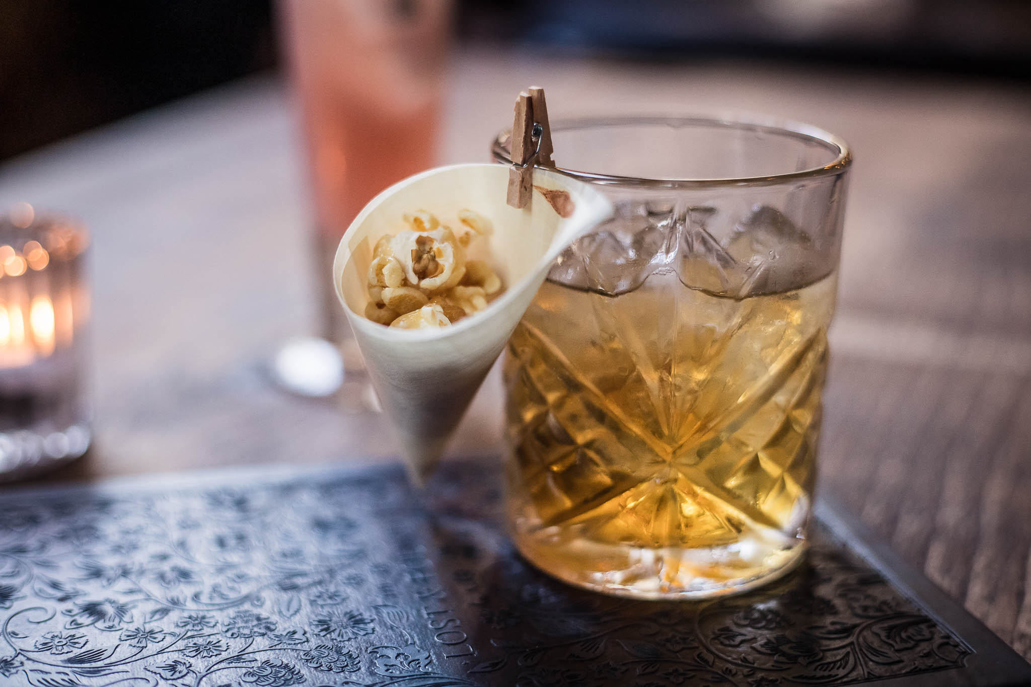 Popcorn Old Fashioned cocktail with a mini cone of popcorn at The Lost and Found in Birmingham