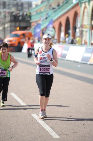Holly running with a big smile along the Brighton seafront at Brighton Marathon 2013