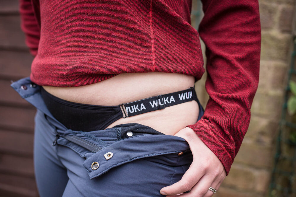 Woman wearing WUKA Flex period pants with logo strap